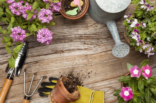 Landscaping crew managing tools and site hazards carefully